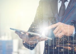 A man checking a tablet with stocks on it