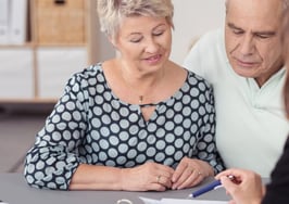 An older couple talking to a broker