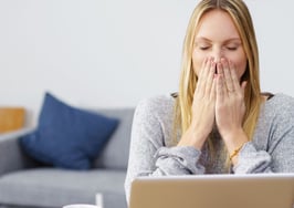 A woman upset at something she sees on a screen