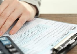 A woman filling out a tax form