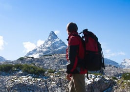 A woman looking ahead at a mountain range
