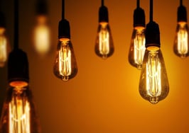 A series of light bulbs on a warm gradient background