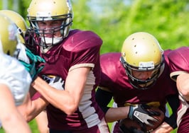 Football players blocking each other during a game