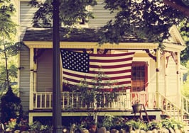 An American flag in front of a home