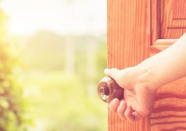 A woman's hand opening a door