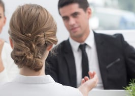 A man and woman interviewing a young woman