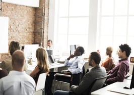 A woman training a room full of people