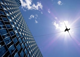 A tightrope walker between two buildings