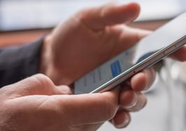 A man using iMessage on a phone