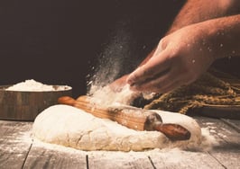 A man kneading bread dough