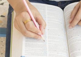 A woman researching in a dictionary