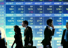 A group of people in front of a stock exchange