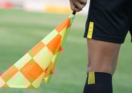 An umpire waving a flag