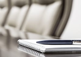 An empty seat at a board room table