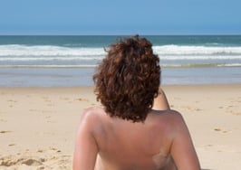 A woman on a nudist beach