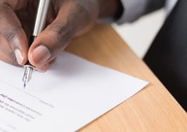 Hand signing a signature on a document