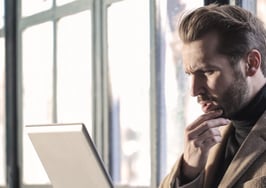 Questions inquisitive man with computer