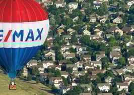 RE/MAX balloon floating over homes