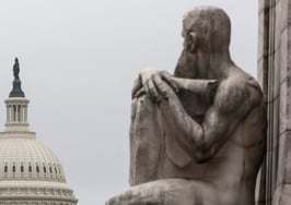 Justice Department statue and Capitol building