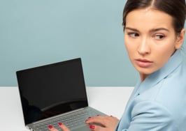 Woman looking worried sad over laptop computer