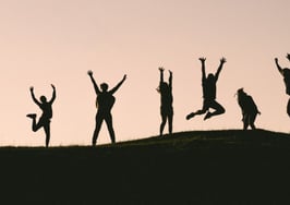 Silhouettes of people jumping