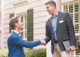Men shaking hands on a front porch