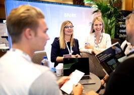Conference exhibitors talking to prospects