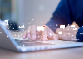 man typing on laptop