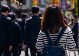 people walking down a busy city street