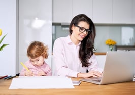 woman working from home with child