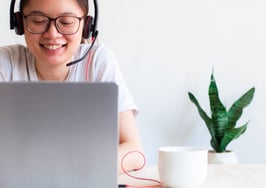 A young Southeast Asian woman doing freelance work at home using a laptop