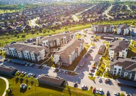 Apartments and Suburbs in Austin Texas - aerial drone view at sunrise with lens flare above new developments