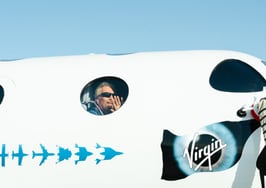 Richard Branson waves from the window of the VSS Unity22 on July 11, 2021 before its spaceflight.