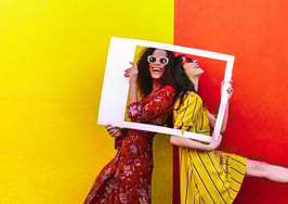 Two women posing for an Instagram picture to represent Instagram boosting SEO.