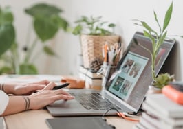 woman working at desk with plants