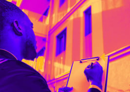A man going through a checklist outside of a home to illustrate creating a seller safety plan.