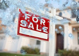 A listing with a for-sale sign and snow flakes falling to represent a listing that has gone cold or that isn't selling.