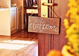 A welcome sign on a front door to symbolize a new agent's guide to home showings