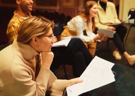 A woman working on memorizing a script to represent canned real estate scripts.