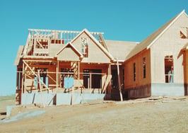 A new home under construction representing new-home sales