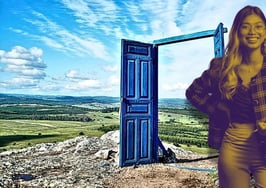 A professional woman standing in front of an open door outline in front of a vast land of opportunity to represent unconventional open house strategies that open up new doors for real estate agents.