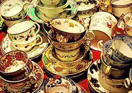 Dozens of tea cups and saucers to represent real estate communication etiquette.