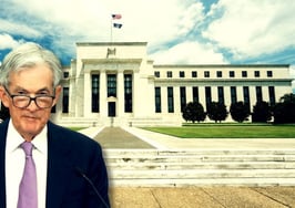 Fed Chair Jerome Powell standing in front of the Federal Reserve building to illustrate how the federal reserve impacts real estate.