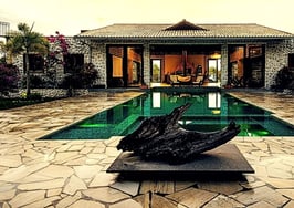 A mansion with a pool and sculpture to exemplify bespoke real estate marketing.