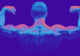 A muscular man with his back to the camera flexing his arm muscles