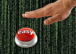 An easy button in front of a wall of code to symbolize AI and custom GPTs for real estate.