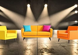 furniture on a lit stage to represent home staging