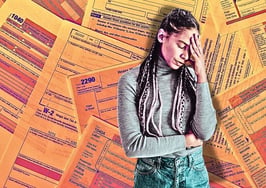 An image of a stressed woman standing in front of IRS forms to symbolize year-end tax planning tips real estate agents.