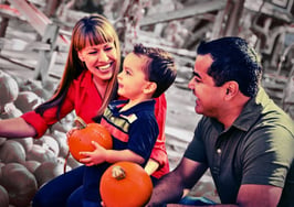 real estate agent hosting fall community event with pumpkins