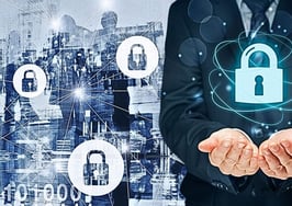 A picture of a man holding a digital lock in front of a digital background to signify deepfakes, AI slop and virtual staging.